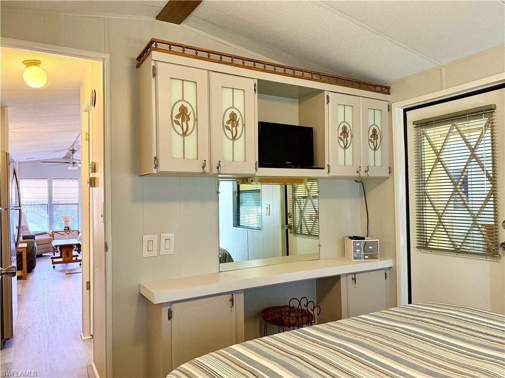 16 Bass Lane, Unit 16 Naples, FL 34114 - Photo 21 of 45 a spacious bathroom with a sink a mirror and next to a window