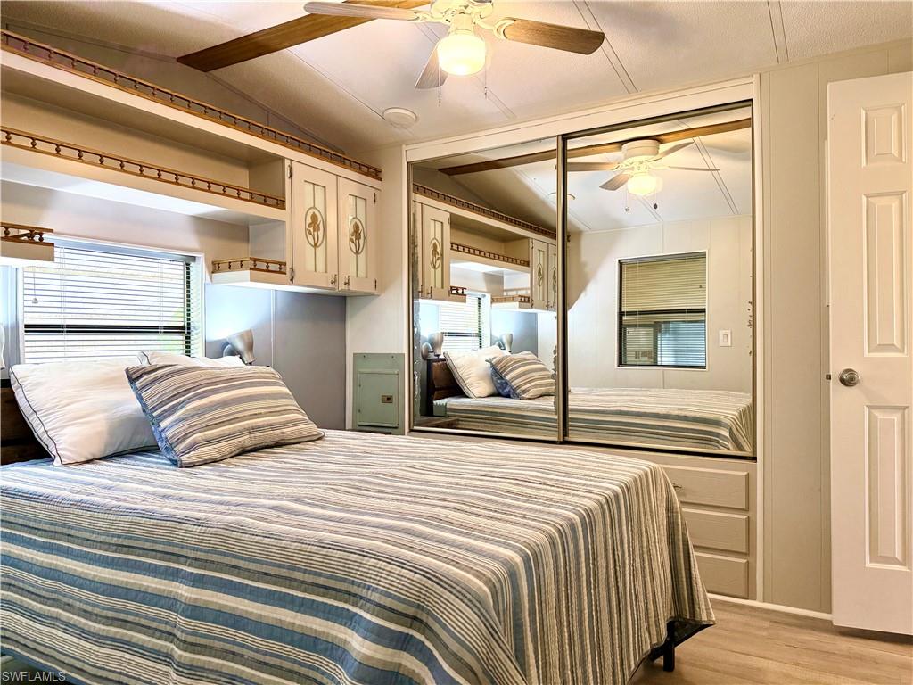 16 Bass Lane, Unit 16 Naples, FL 34114 - Photo 23 of 45 a bedroom with a bed and a mirror