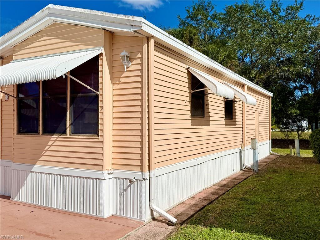 16 Bass Lane, Unit 16 Naples, FL 34114 - Photo 3 of 45 a view of a house with a yard and wooden floor