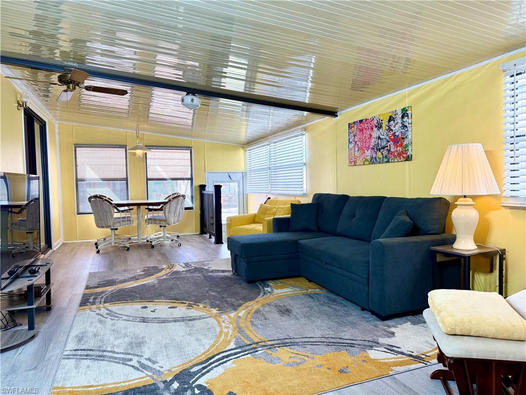 16 Bass Lane, Unit 16 Naples, FL 34114 - Photo 8 of 45 a living room with furniture and a table