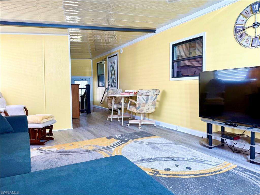 16 Bass Lane, Unit 16 Naples, FL 34114 - Photo 9 of 45 a living room with furniture and a flat screen tv