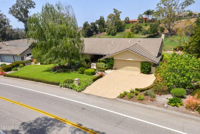 an aerial view of a house with a garden and trees