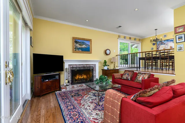 a living room with furniture flat screen tv and a fireplace