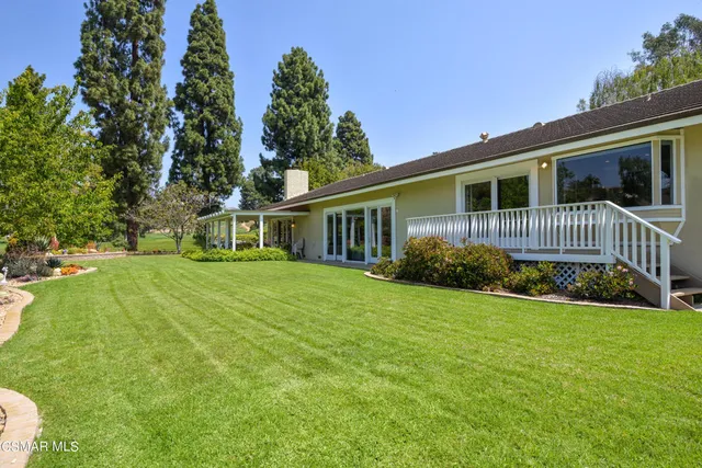 a front view of a house with yard and green space