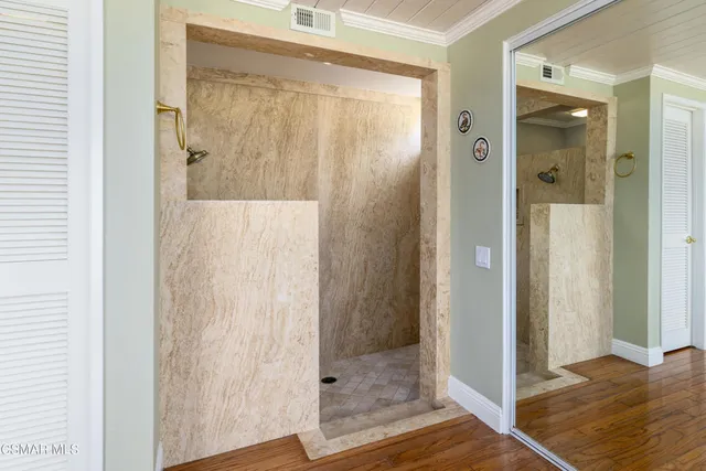 a bathroom with a glass shower door
