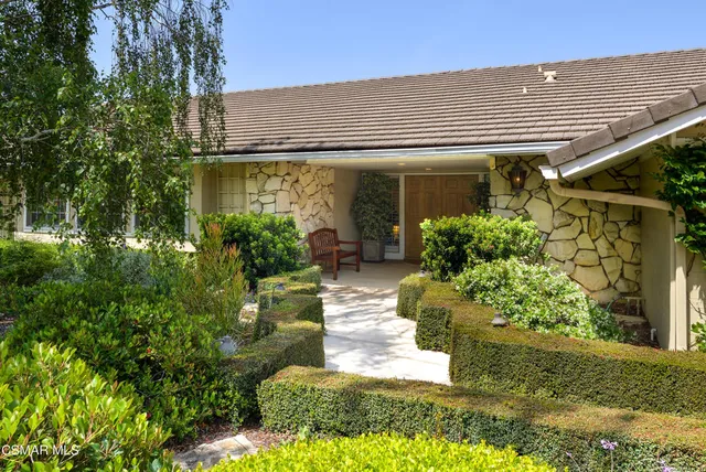 a front view of a house with garden