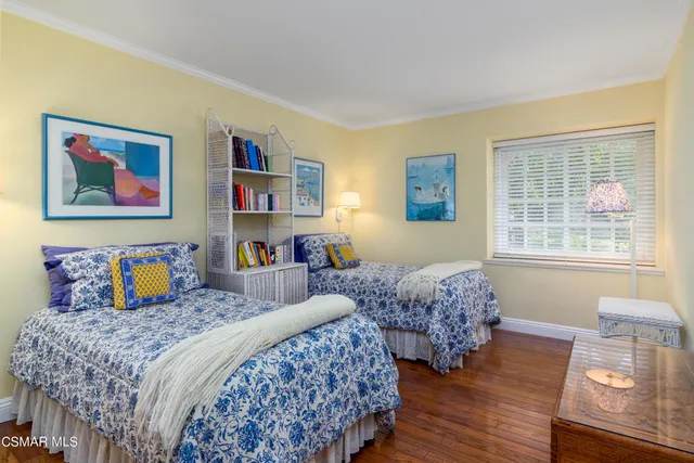 a bedroom with two beds and a window