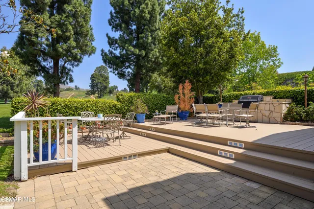 a view of a patio with a table and chairs and couches