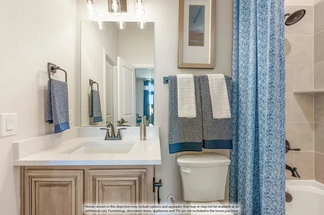 a bathroom with a granite countertop sink a toilet and mirror