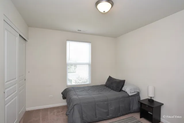 a bedroom with a bed and window