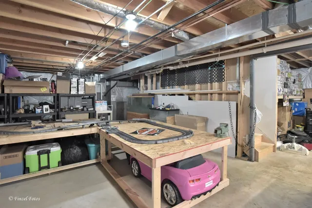 a utility room with stainless steel appliances granite countertop a sink a stove and cabinets