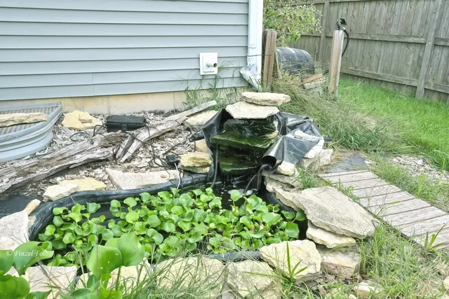 a backyard of a house with table and chairs