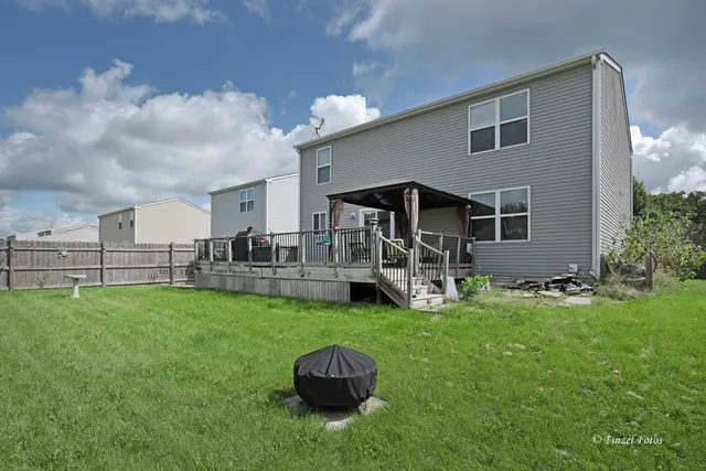 a backyard of a house with table and chairs