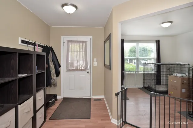 a view of hallway with stairs and wooden floor