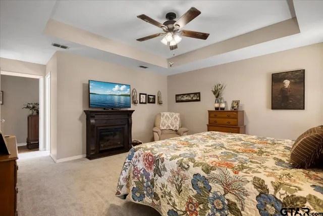 a bedroom with a bed and a television