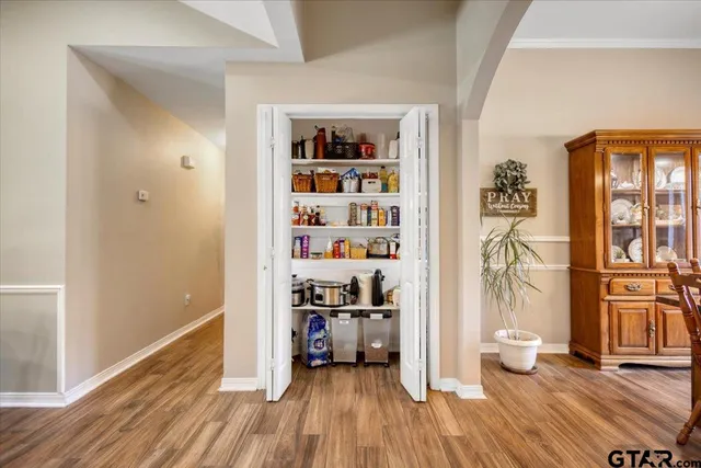 a view of a hardwood floor and windows in a room