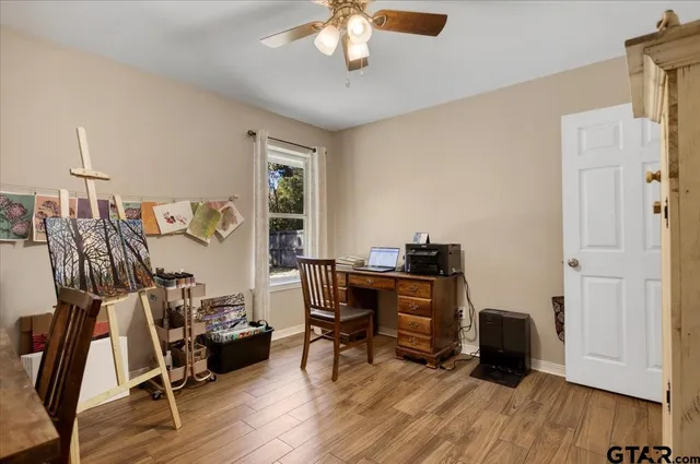 a view of a workspace with furniture and wooden floor