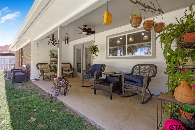 a view of a patio with dining table and chairs with plants