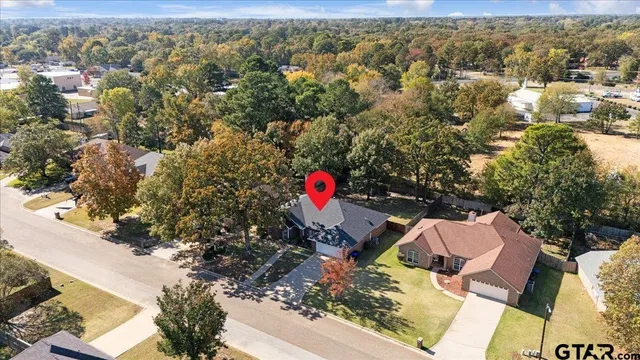 an aerial view of residential house with outdoor space and trees