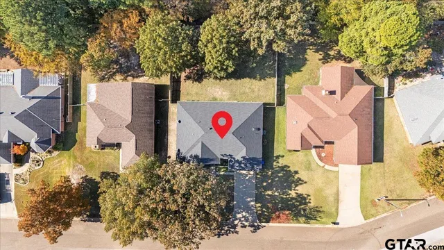 an aerial view of residential houses with trees