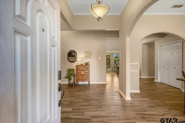 a view of a hallway view with wooden floor and staircase