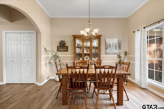 a view of a dining room with furniture wooden floor and chandelier