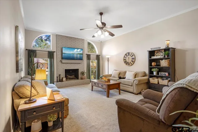 a living room with furniture a fireplace and a flat screen tv