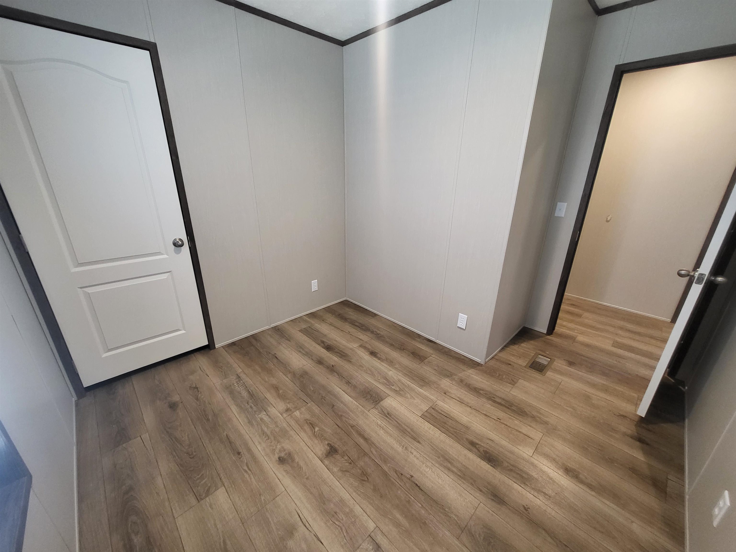 148 Holly Berry Way Fruita, CO 81521 - Photo 11 of 19 a view of empty room with wooden floor