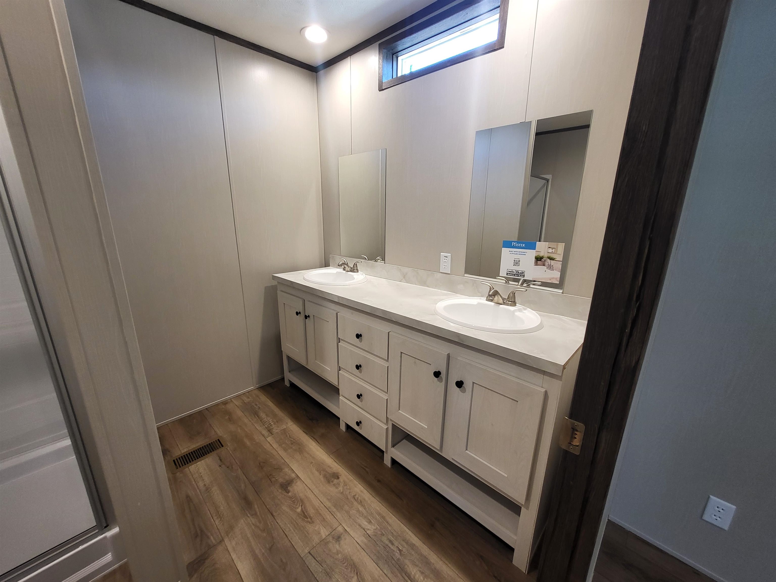 148 Holly Berry Way Fruita, CO 81521 - Photo 13 of 19 a bathroom with a double vanity sink and mirror