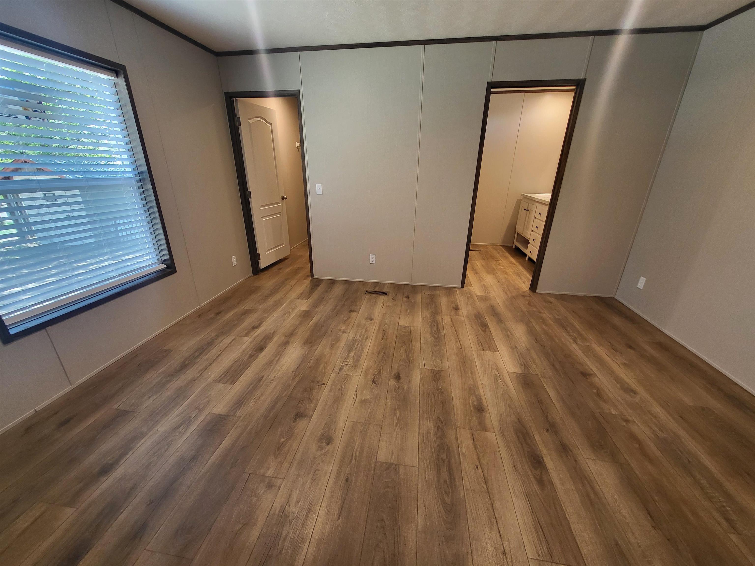 148 Holly Berry Way Fruita, CO 81521 - Photo 15 of 19 a view of empty room with wooden floor