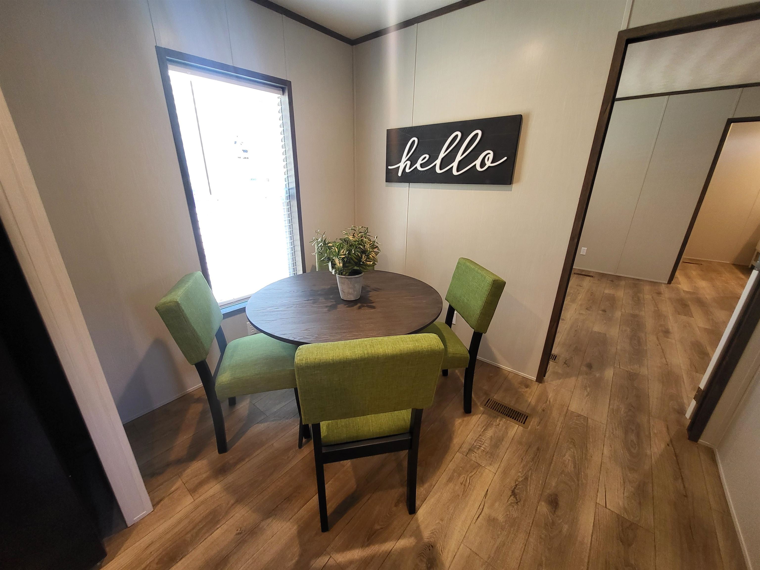148 Holly Berry Way Fruita, CO 81521 - Photo 7 of 19 a view of a dining room with furniture and wooden floor