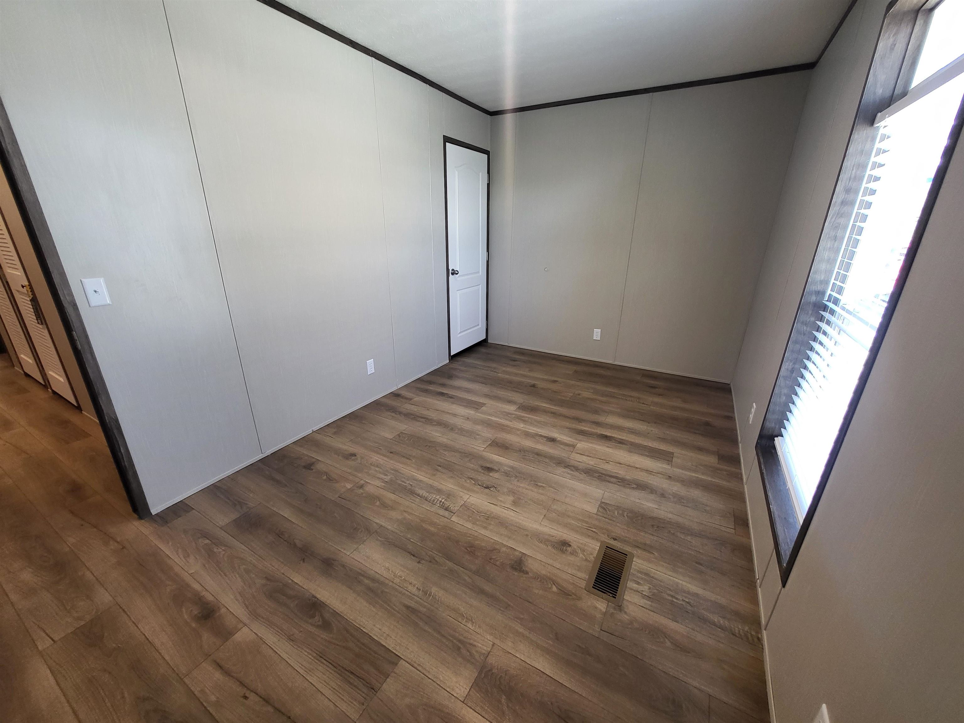 148 Holly Berry Way Fruita, CO 81521 - Photo 8 of 19 a view of a room with wooden floor and windows