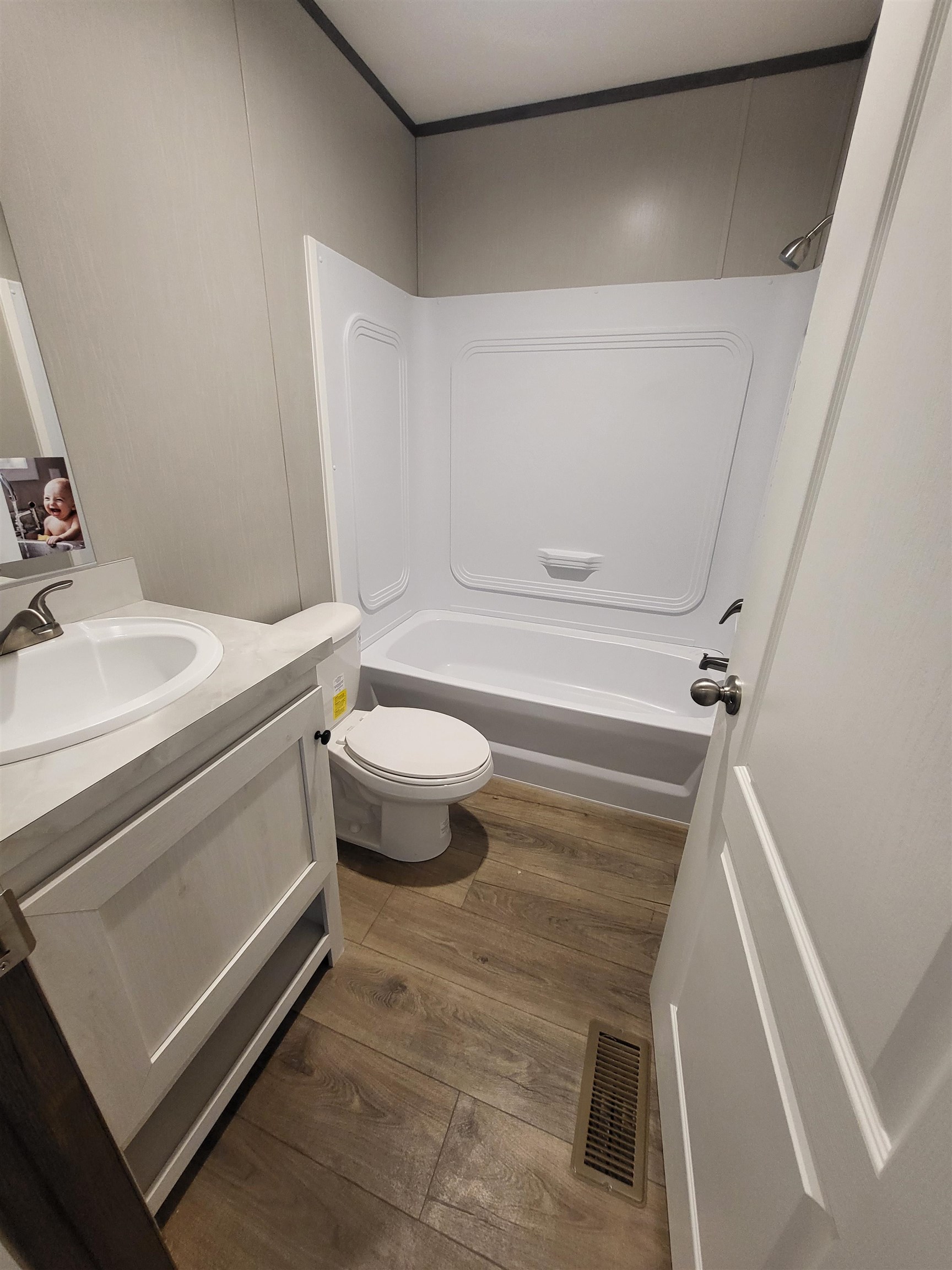 148 Holly Berry Way Fruita, CO 81521 - Photo 9 of 19 a bathroom with a sink a toilet and a mirror