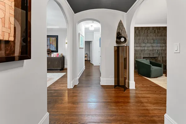 a view of a hallway with wooden floor fireplace and living room