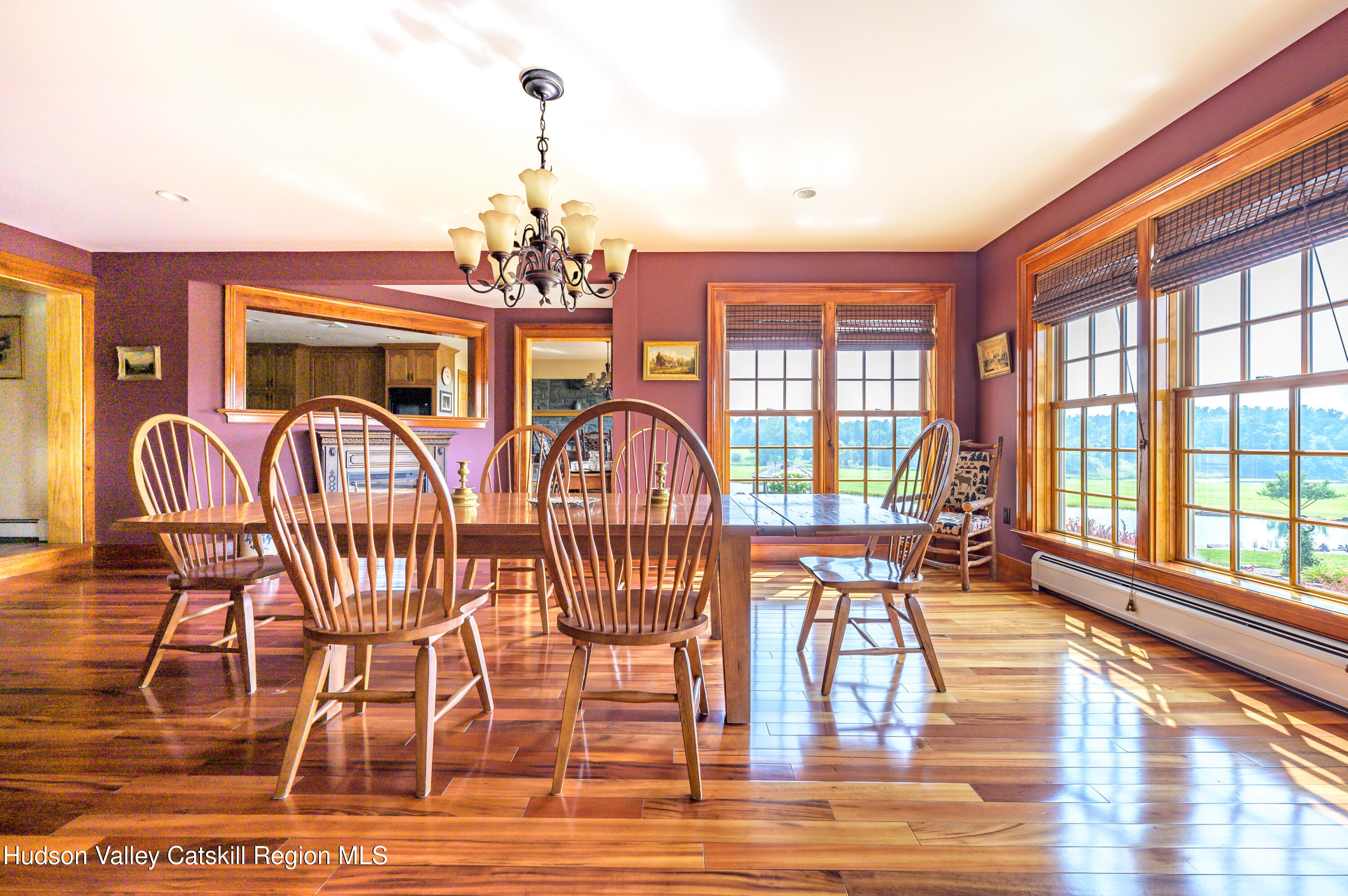 520 Ridge Road Stuyvesant, NY 12156 - Photo 16 of 68 a view of a dining room with furniture a chandelier and wooden floor