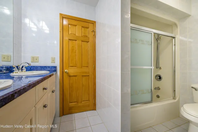 a living room with a couch and a bookshelf