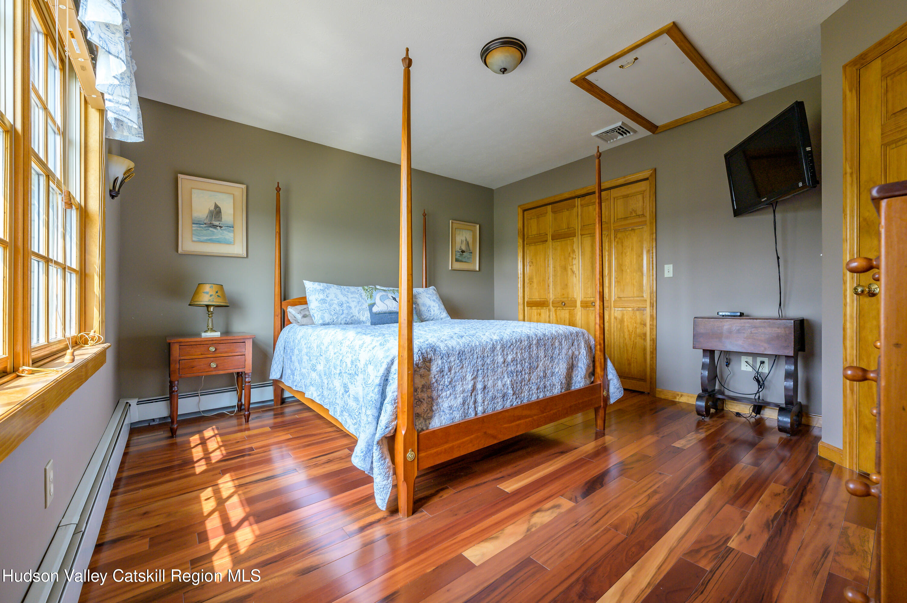 520 Ridge Road Stuyvesant, NY 12156 - Photo 30 of 68 a bedroom with a bed and wooden floor