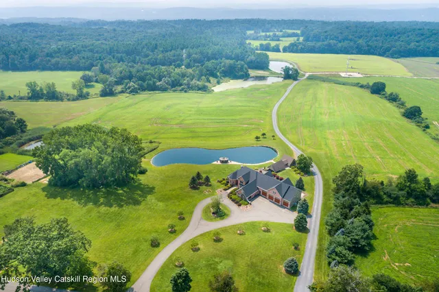 an aerial view of a house with a yard basket ball court and outdoor seating