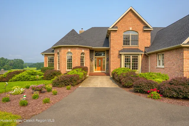 a view of a house with pool and chairs