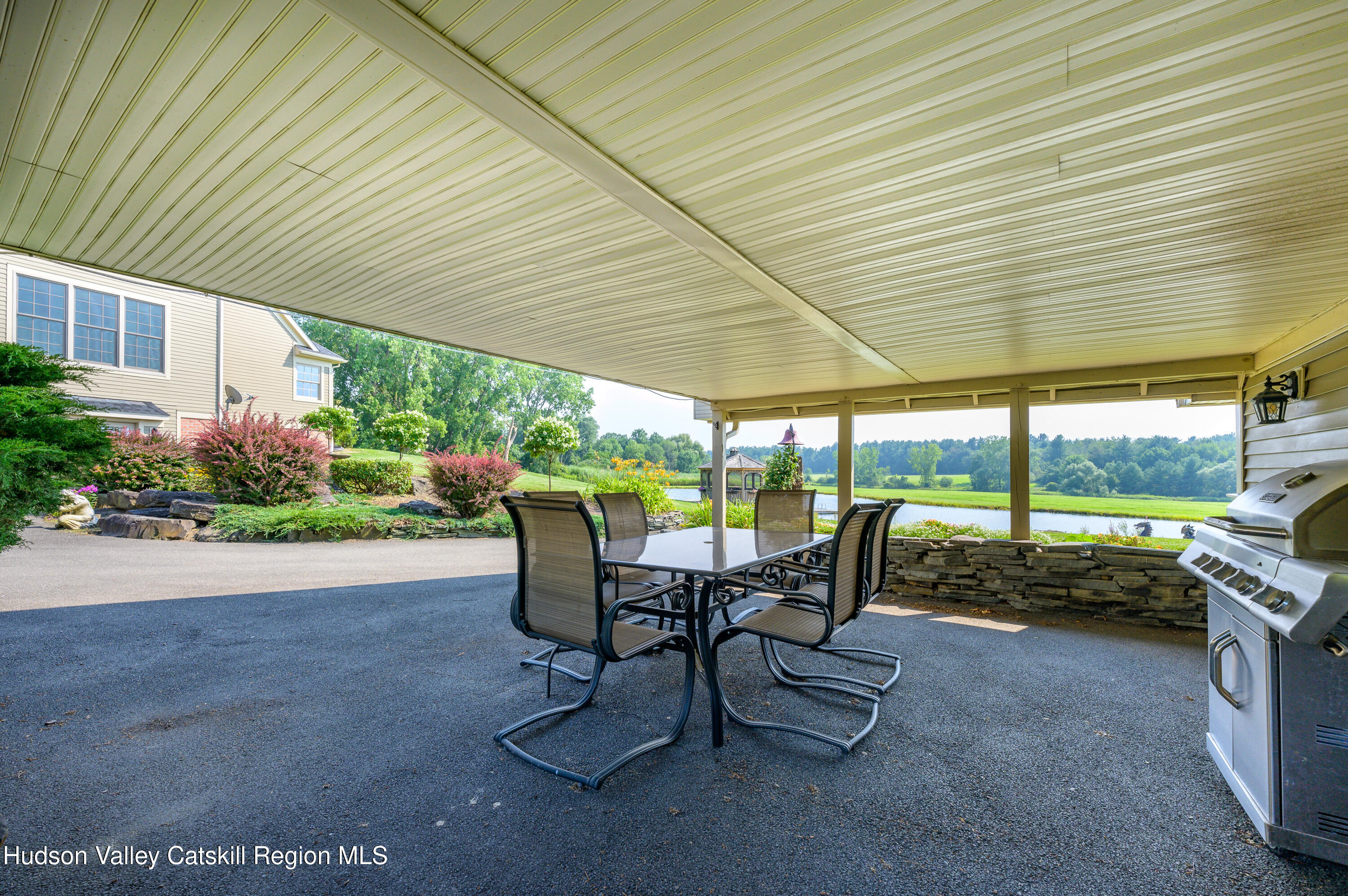 520 Ridge Road Stuyvesant, NY 12156 - Photo 62 of 68 a view of a patio with table and chairs and potted plants