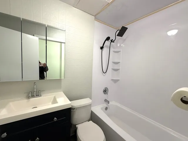 a bathroom with a sink toilet tub and shower