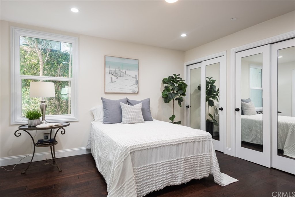 1609 Chestnut Avenue Manhattan Beach, CA 90266 - Photo 16 of 26 a bedroom with a bed and wooden floor