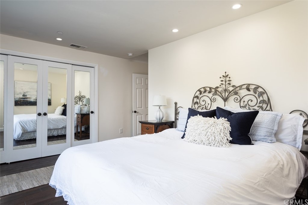 1609 Chestnut Avenue Manhattan Beach, CA 90266 - Photo 19 of 26 a bedroom with a bed and a chandelier