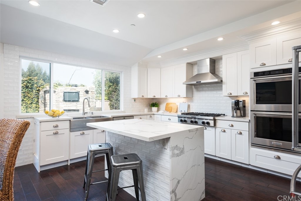1609 Chestnut Avenue Manhattan Beach, CA 90266 - Photo 9 of 26 a kitchen with stainless steel appliances a stove a sink a microwave a refrigerator and cabinets