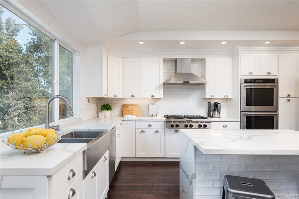 1609 Chestnut Avenue Manhattan Beach, CA 90266 - Photo 10 of 26 a kitchen with stainless steel appliances granite countertop a stove a sink and a refrigerator