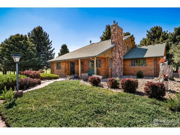 a group of table and chairs in front of house