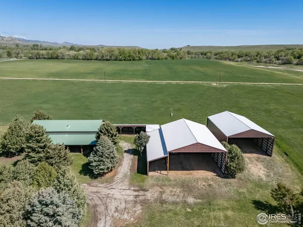 an aerial view of a house with garden space and ocean view