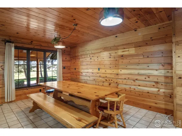 a room with pool table and glass windows