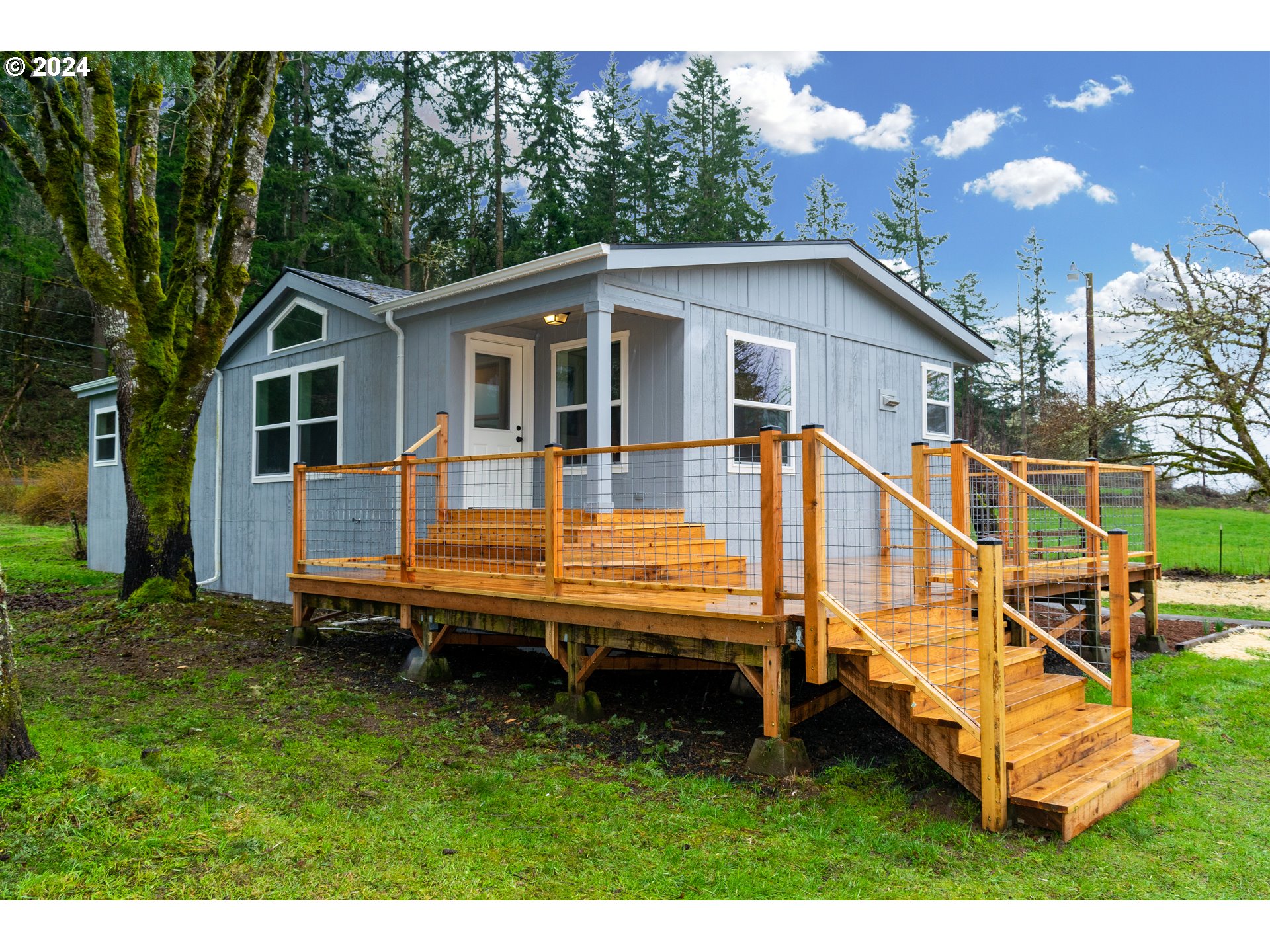 28157 Cottage Grove Lorane Road Cottage Grove, OR 97424 - Photo 1 of 33 a backyard of a house with wooden floor and fence