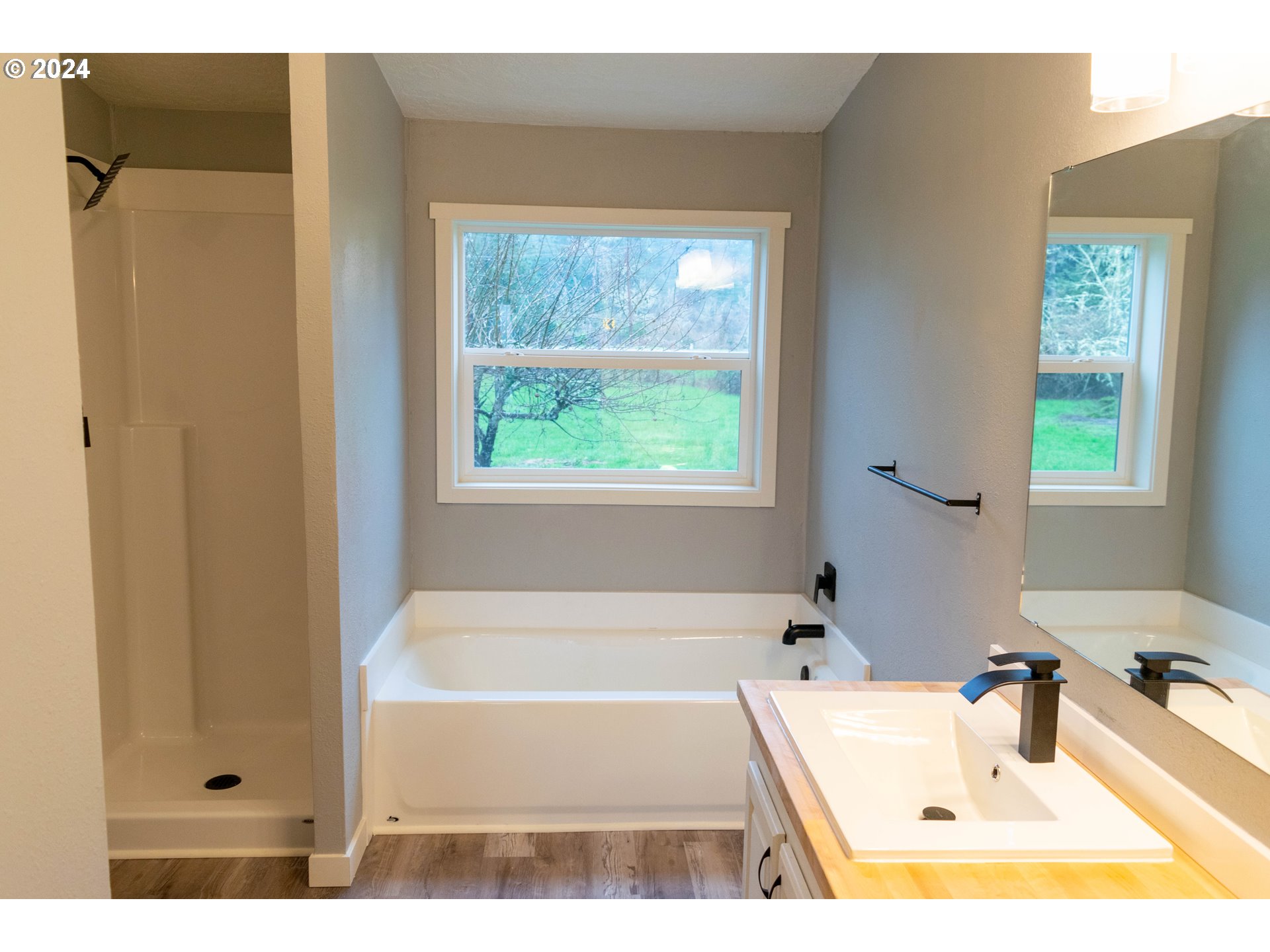28157 Cottage Grove Lorane Road Cottage Grove, OR 97424 - Photo 15 of 33 a bathroom with a tub a sink and a window
